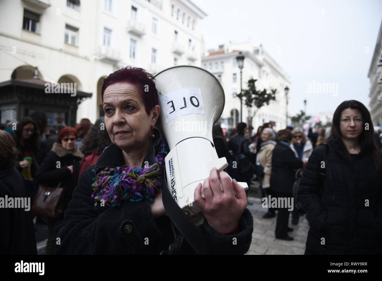 Thessaloniki, Greece. 8th Mar, 2019. A woman holds a speaker during a protest. Due to International Women's Day women of the Hellenic Women Federation demonstrated at the center of the city, demanding equal rights with men in the labor sector and improvement on the working conditions of working mothers. Credit: Giannis Papanikos/ZUMA Wire/Alamy Live News Stock Photo