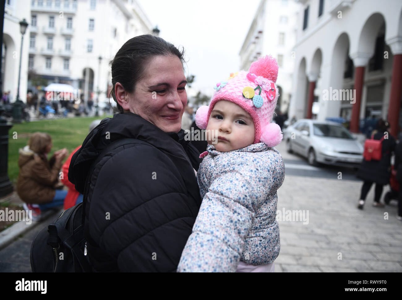 Thessaloniki, Greece. 8th Mar, 2019. A woman with a baby takes part in a protest. Due to International Women's Day women of the Hellenic Women Federation demonstrated at the center of the city, demanding equal rights with men in the labor sector and improvement on the working conditions of working mothers. Credit: Giannis Papanikos/ZUMA Wire/Alamy Live News Stock Photo