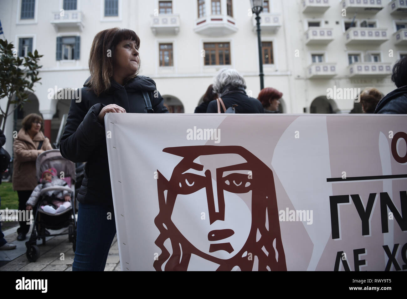 Thessaloniki, Greece. 8th Mar, 2019. A woman holds a banner during a protest. Due to International Women's Day women of the Hellenic Women Federation demonstrated at the center of the city, demanding equal rights with men in the labor sector and improvement on the working conditions of working mothers. Credit: Giannis Papanikos/ZUMA Wire/Alamy Live News Stock Photo