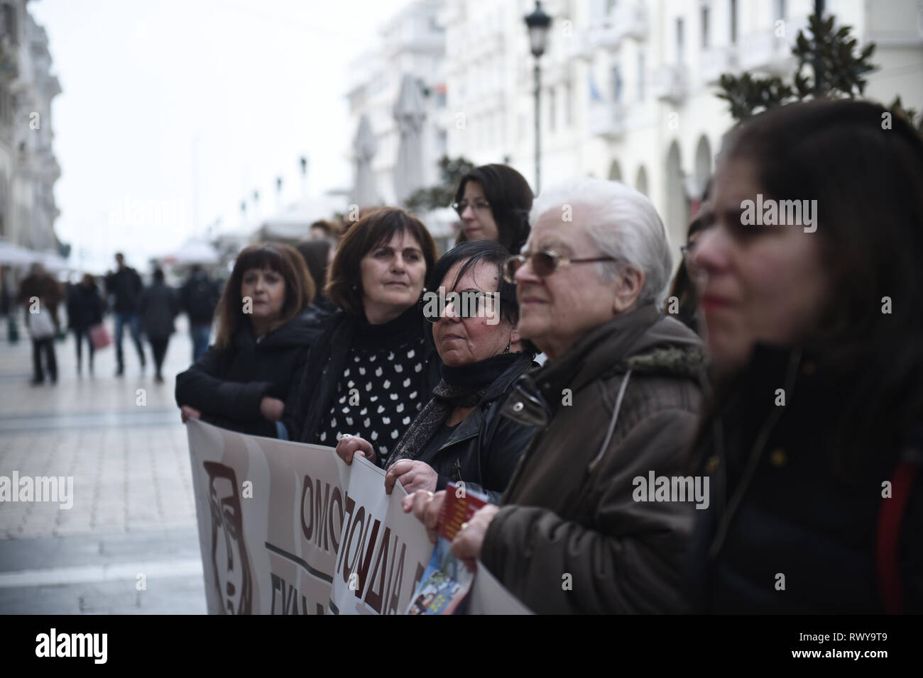 Thessaloniki, Greece. 8th Mar, 2019. Women hold a banner during a protest. Due to International Women's Day women of the Hellenic Women Federation demonstrated at the center of the city, demanding equal rights with men in the labor sector and improvement on the working conditions of working mothers. Credit: Giannis Papanikos/ZUMA Wire/Alamy Live News Stock Photo