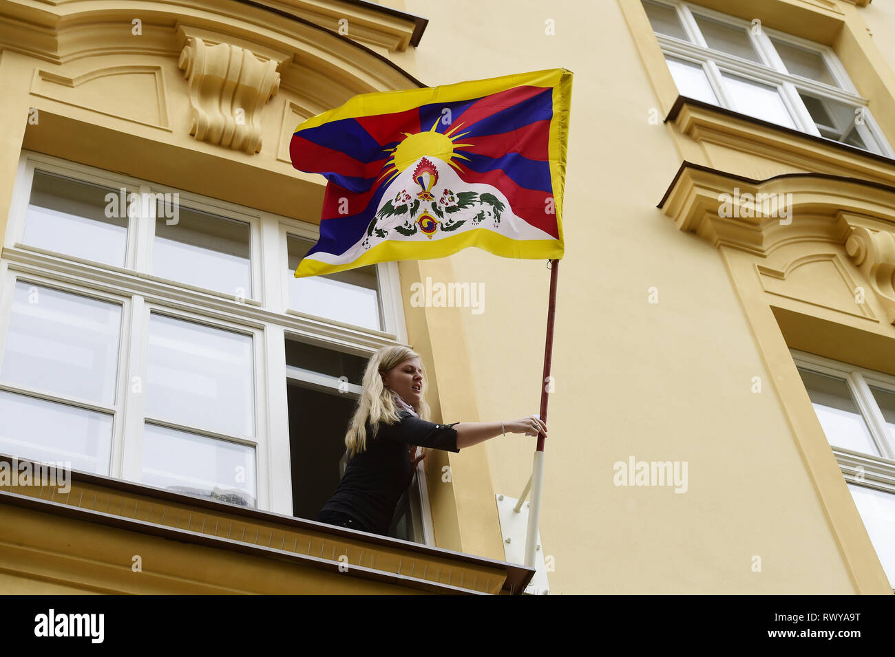 Olomouc, Czech Republic. 08th Mar, 2019. Hana Ferencova, member of Department of History of Palacky University Olomouc, hang up the Tibetan flag on the building of Faculty of Philosophy, in Olomouc, Czech Republic, on March 8, 2019, as a symbolic reminder of the anti-Chinese uprising in 1959. Credit: Ludek Perina/CTK Photo/Alamy Live News Stock Photo