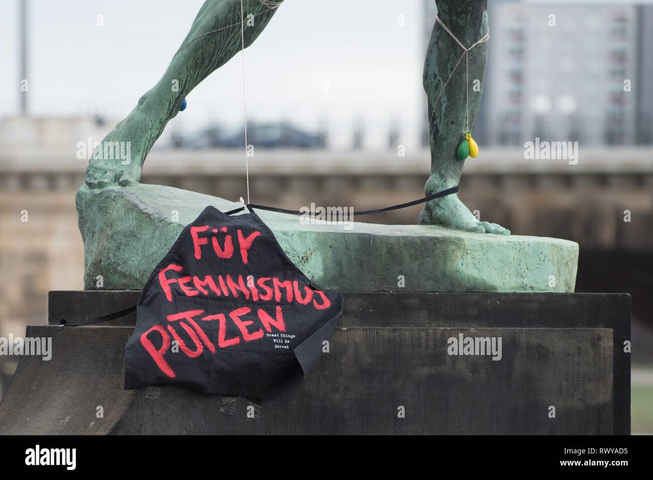 Dresden, Germany. 08th Mar, 2019. A black fabric with the inscription 'Für Feminismus Putzen' hangs on the sculpture 'Archer' by Ernst Moritz Geyger. The action falls on the International Women's Day, which is celebrated on the same day. Credit: Sebastian Kahnert/dpa-Zentralbild/dpa/Alamy Live News Stock Photo