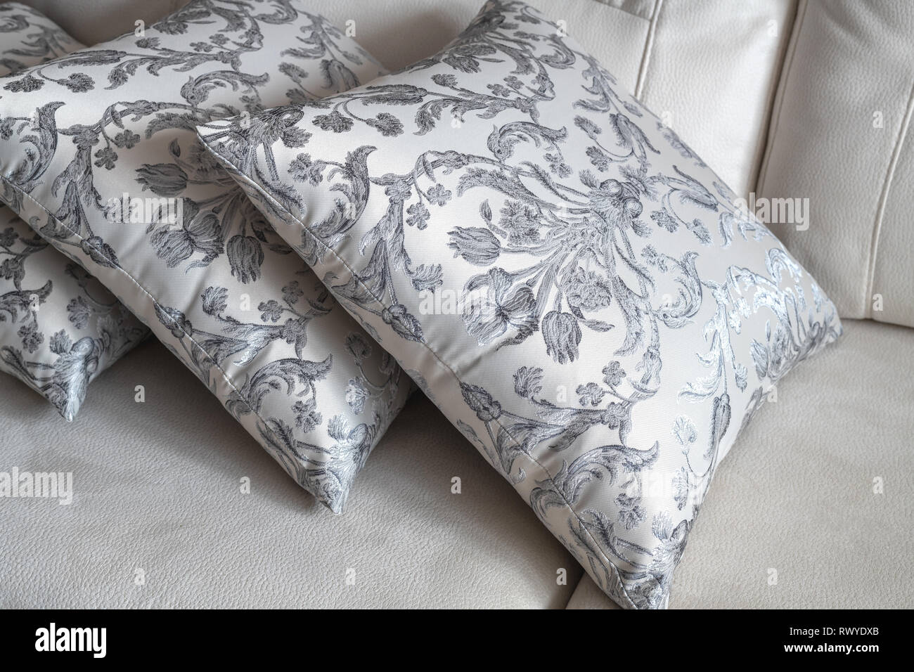 several patterned pillow on the light sofa Stock Photo