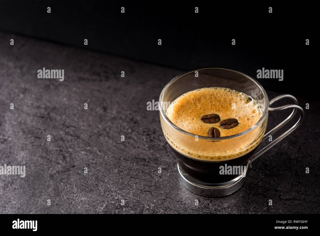 coffee glass and coffee grain on black background. Copyspace Stock Photo