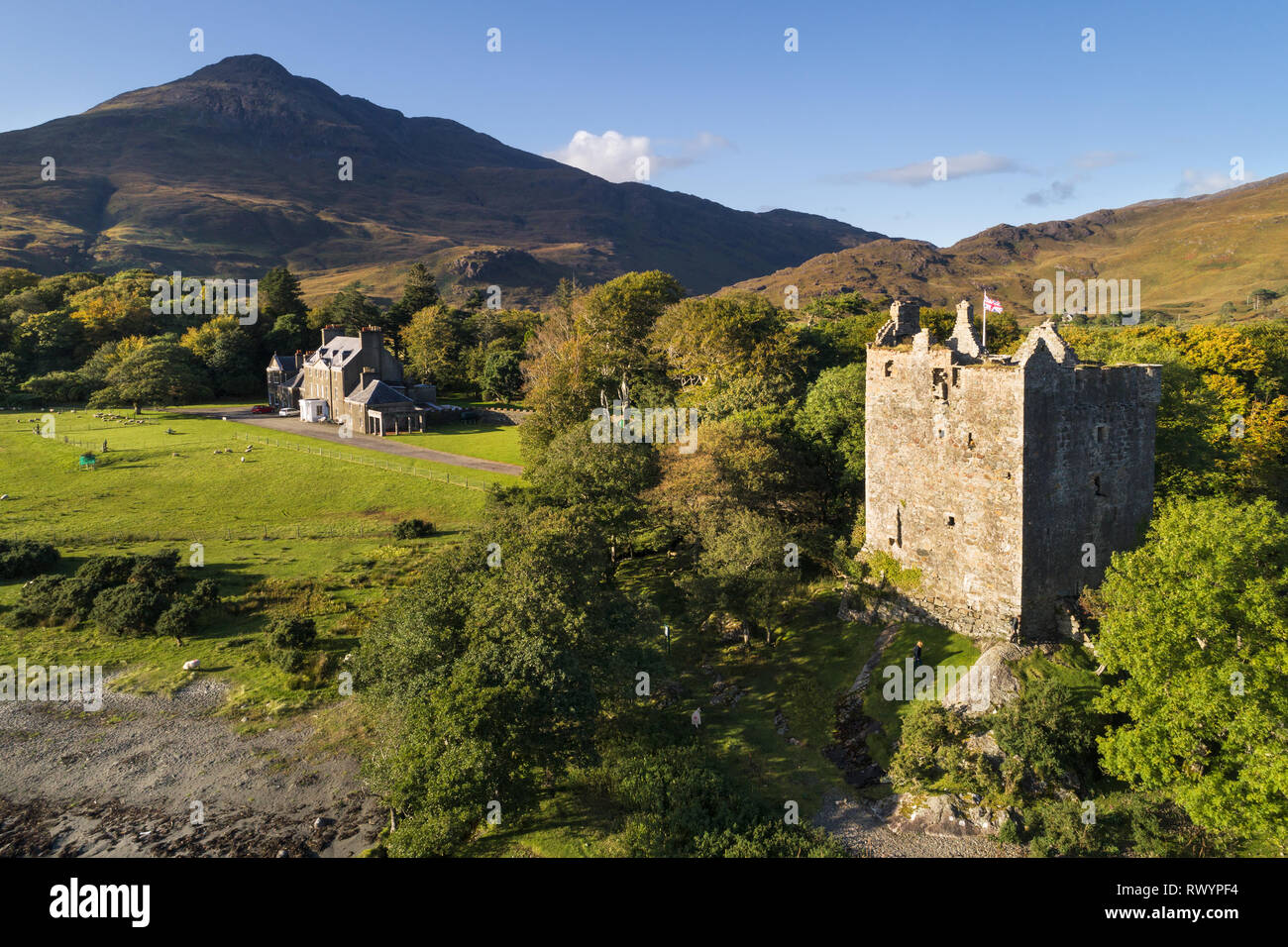 Aerial view of Moy Castle and Lochbuie House in evening sunlight with Lochbuie house and the mountain Ben Buie behind. Stock Photo