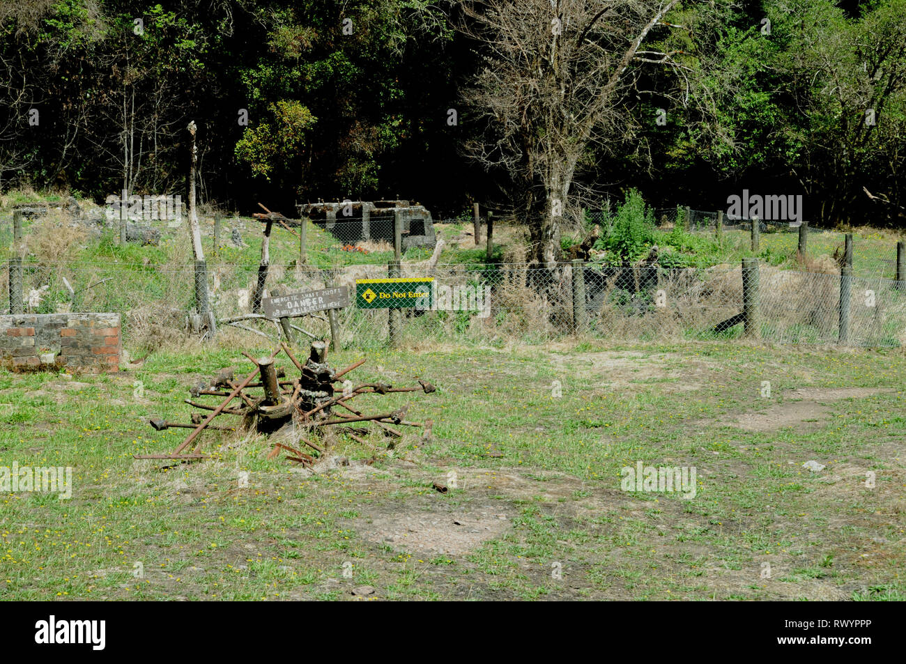 The fenced off site and remains of the main shaft at the 'Energetic Mine' Reefton  in the West Coast region of South Island New Zealand. Stock Photo