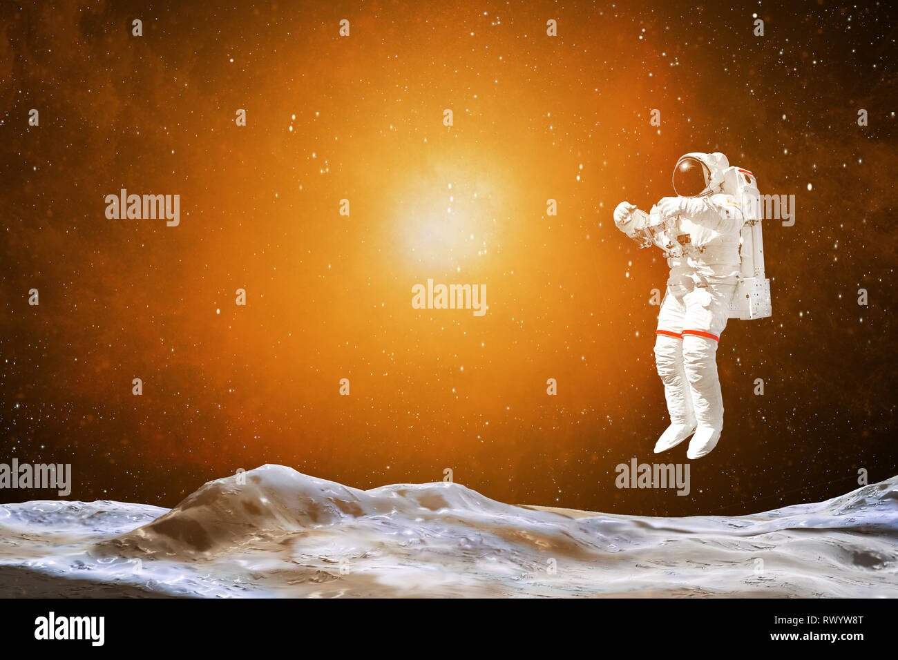 Spaceman in a spacesuit in outer space. Astronaut landing on a planet. Rising sun. Elements of this image furnished by NASA Stock Photo