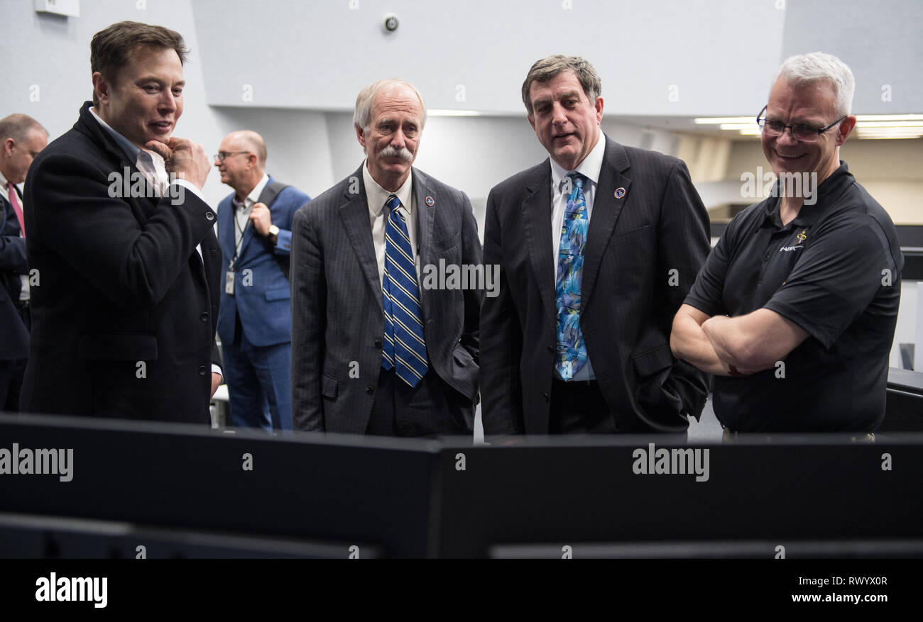 SpaceX CEO and Chief Designer Elon Musk, left, NASA Associate Administrator for the Human Exploration and Operations Mission Directorate William Gerstenmaier, second from left, NASA International Space Station Program Manager Kirk Shireman, second from right, and SpaceX Director of Crew Mission Management Benji Reed, right, watch the progress of the Crew Dragon spacecraft after launch from firing room four at the Kennedy Space Center March 2, 2019 in Cape Canaveral, Florida. Stock Photo