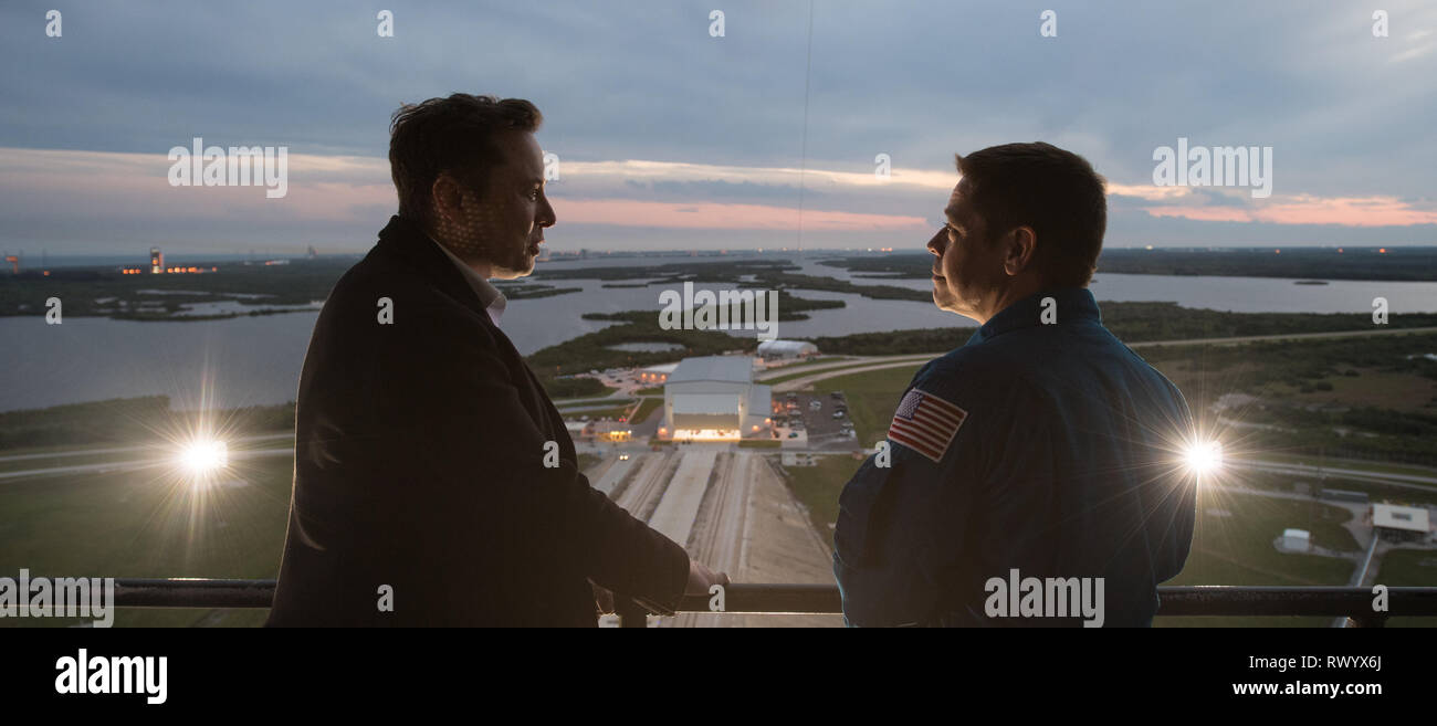 SpaceX CEO and Chief Designer Elon Musk, left, speaks with NASA astronaut Bob Behnken on the fixed service structure of Launch Complex 39A during a tour before the launch of the Demo-1 mission at the Kennedy Space Center March 1, 2019 in Cape Canaveral, Florida. Stock Photo