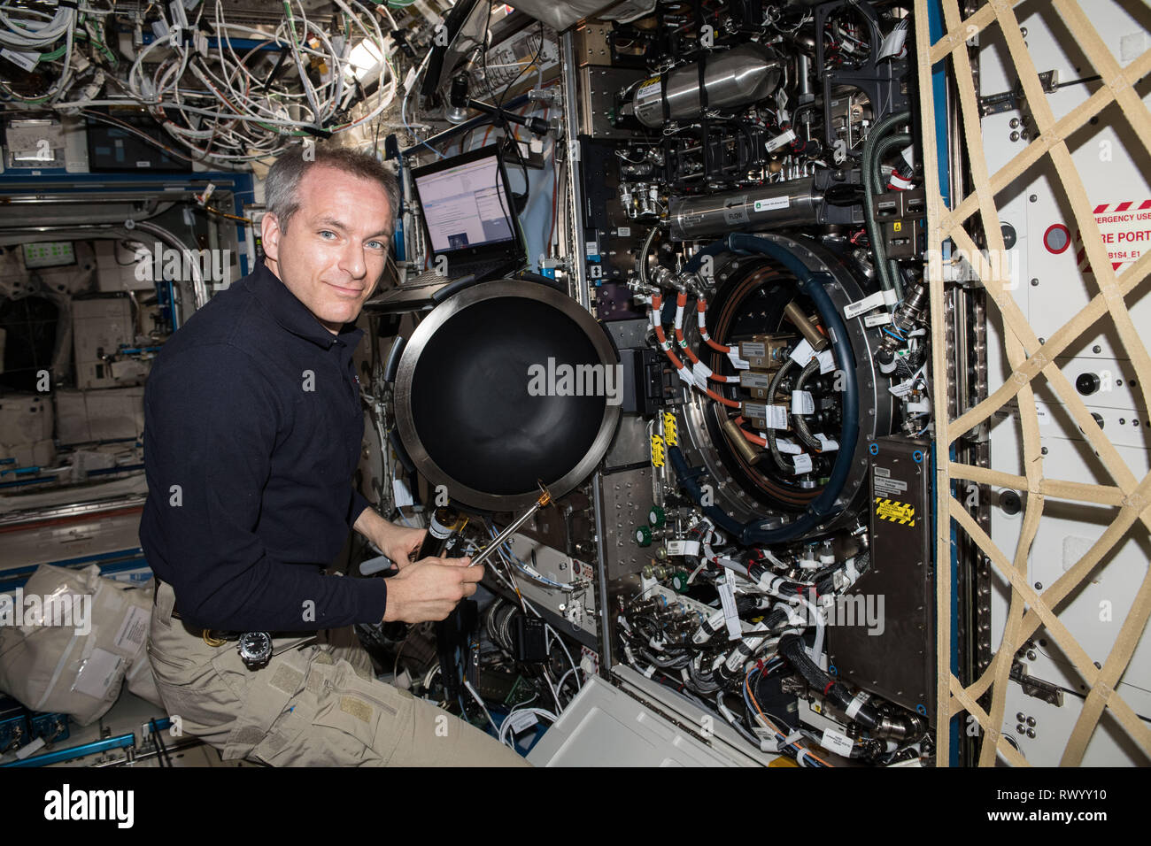 Canadian Space Agency astronaut David Saint-Jacques works inside the U.S. Destiny laboratory module working on the Combustion Integrated Rack aboard the International Space Station February 26, 2019 in Earth Orbit. Saint-Jacques replaced fuel flow controllers inside the device for the Advanced Combustion via Microgravity Experiments which are a set of five independent studies of gaseous flames. Stock Photo