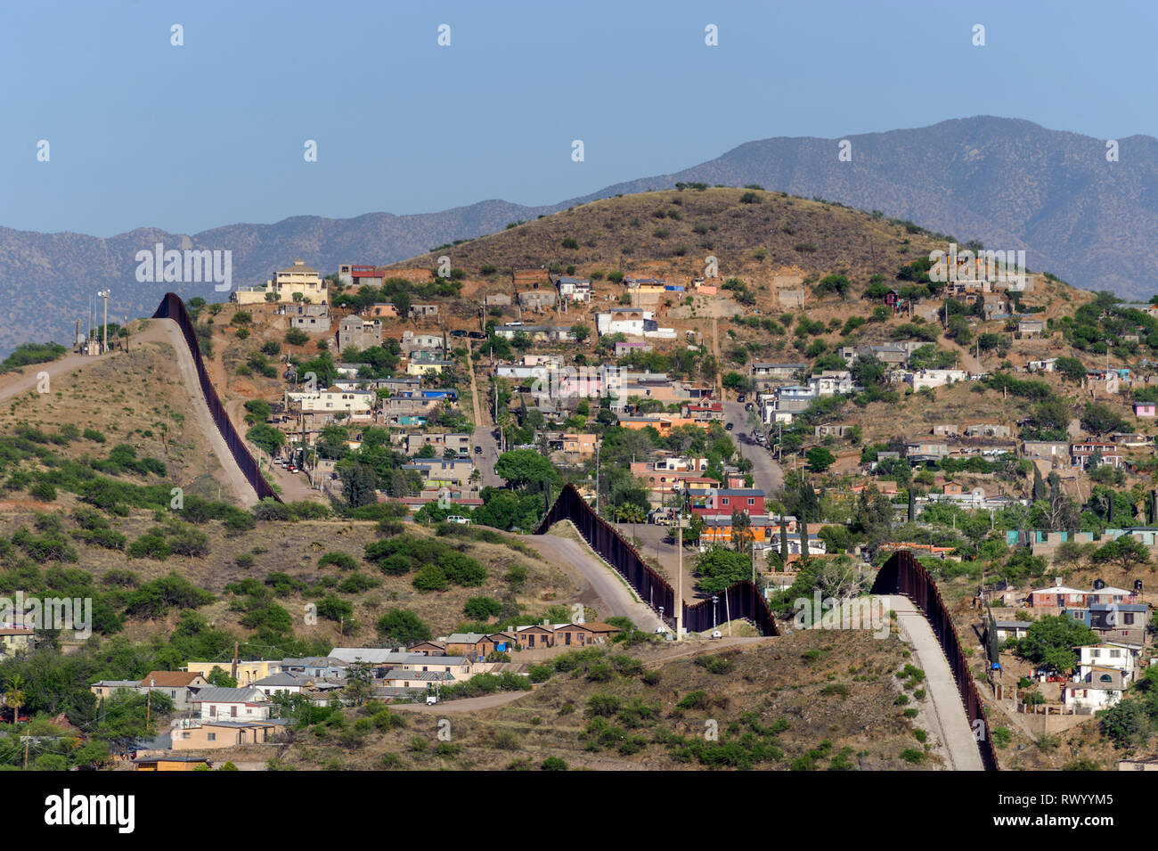 High view over Nogales Sonora Mexico from Nogales Arizona, looking southeast, showing US border fence and hilly terrain, April 2018 Stock Photo