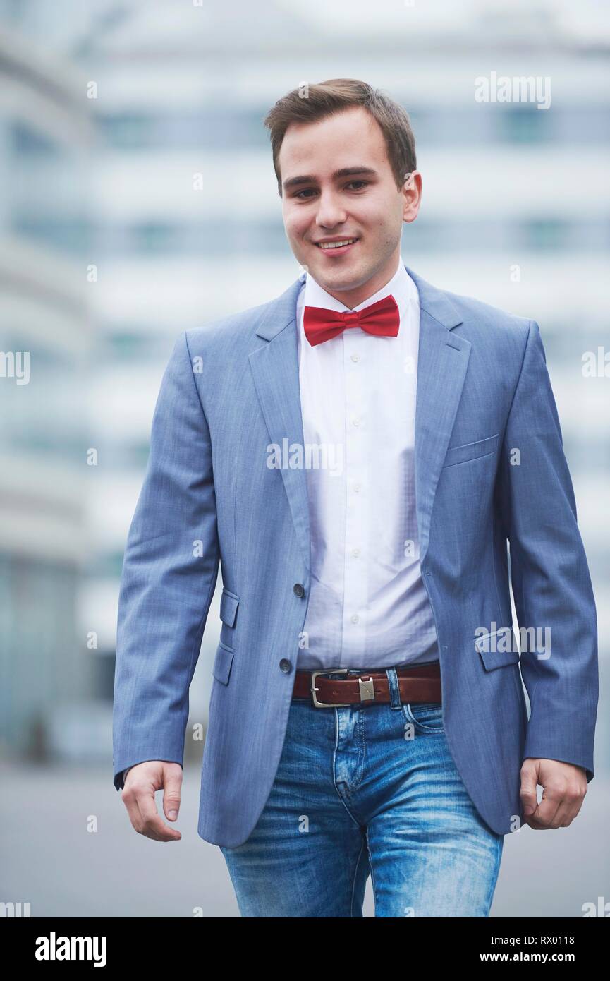 Young business man walking on street, Germany Stock Photo