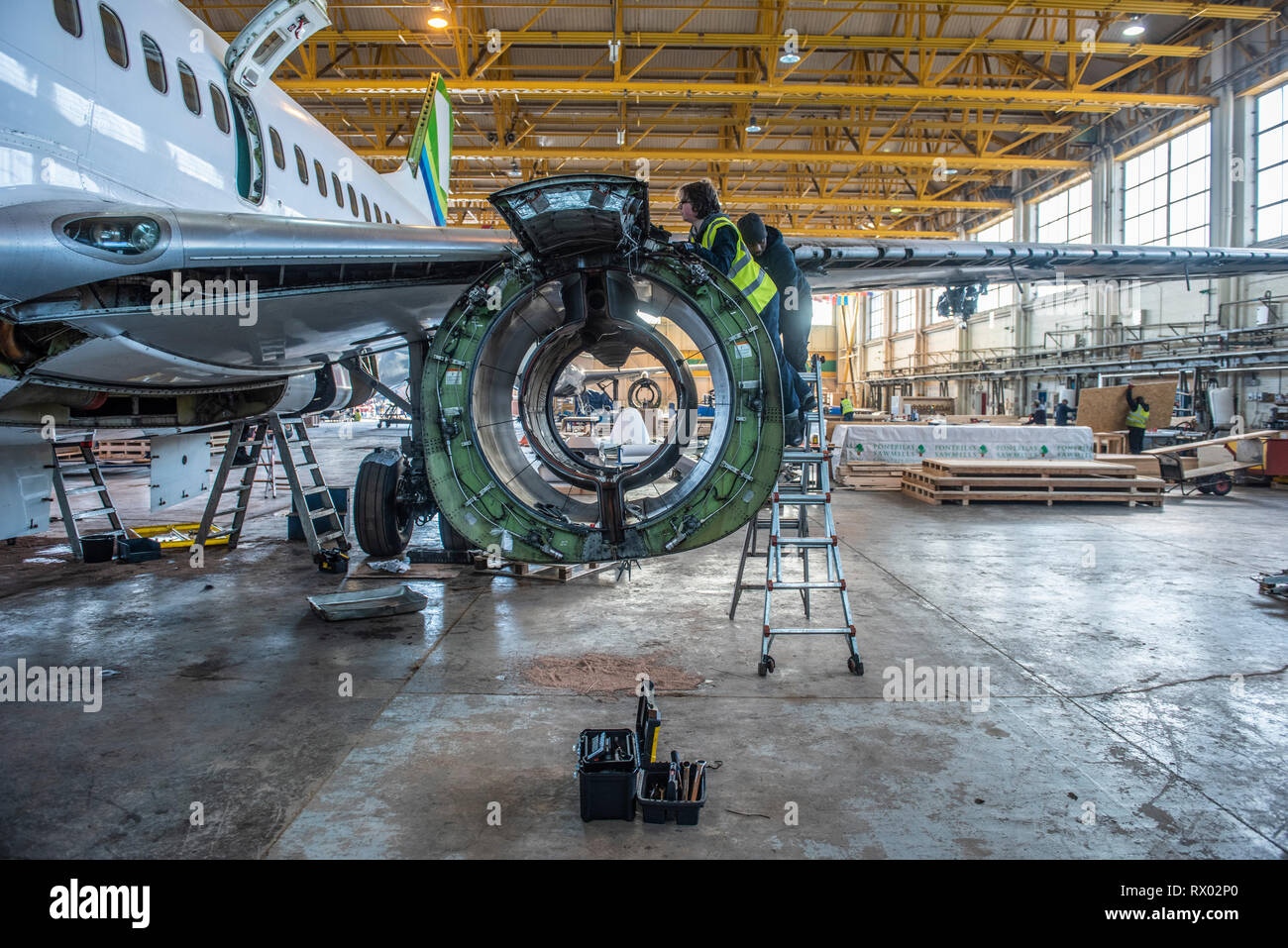 Disassembly of passenger aircraft by E-cube solutions at St Athan's airbase south Wales. Various parts of the aircraft are sold on, re purposed etc. Or whole aircraft can be bought and stripped down or 'teared down' as it's known, according to the customer requirements.The engine's are often the most valuable parts of the aircraft and can be worth as much as 2 - 3 million GBP. This being so many carriers only lease the engines and the owners then decide on their fate once the aircraft has been retired from service. Other parts might be sold off and repurposed as furniture for the home, office Stock Photo