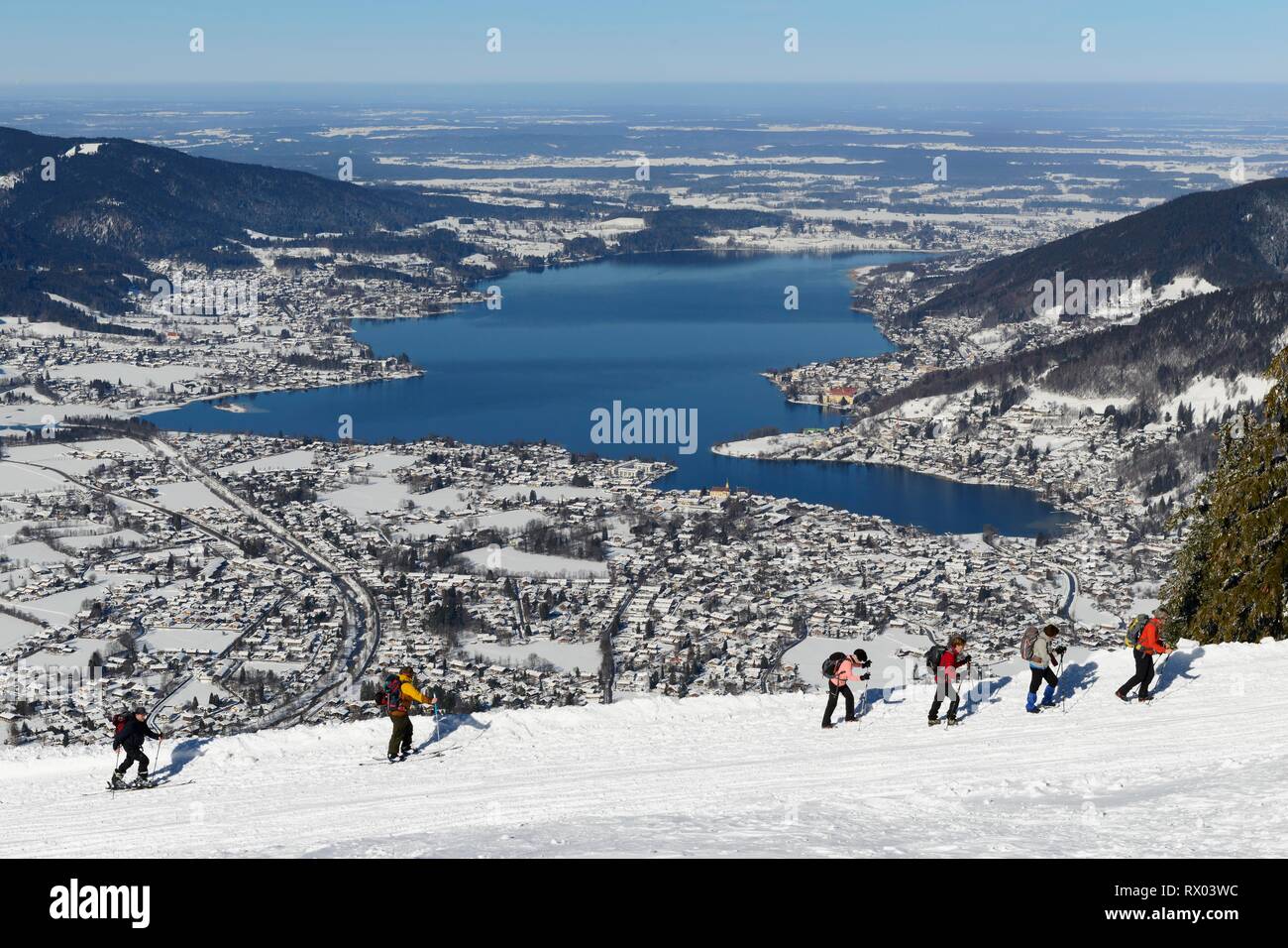 Hikers and ski tourers climb the Wallberg in winter, behind lake Tegernsee, Rottach-Egern, Upper Bavaria, Bavaria, Germany Stock Photo