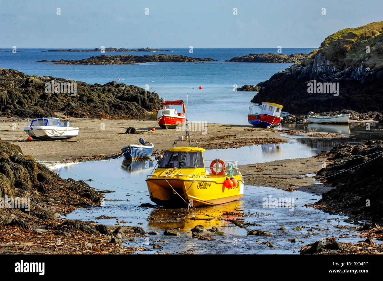 Boats tied up at low tide near Earsairidh, Barra Outer Hebrides, Scotland Stock Photo