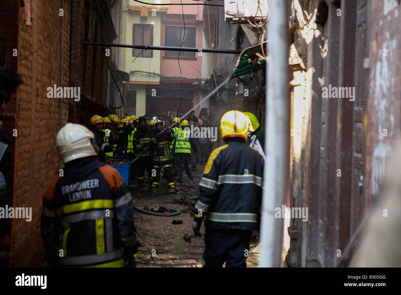 Fire fighters seen working hard to extinguish the fire.  Fire broke out in residential buildings next to the Hanumandhoka Durbar Square injuring three people and three house were blazed. The cause of the fire is uncertain yet. Stock Photo