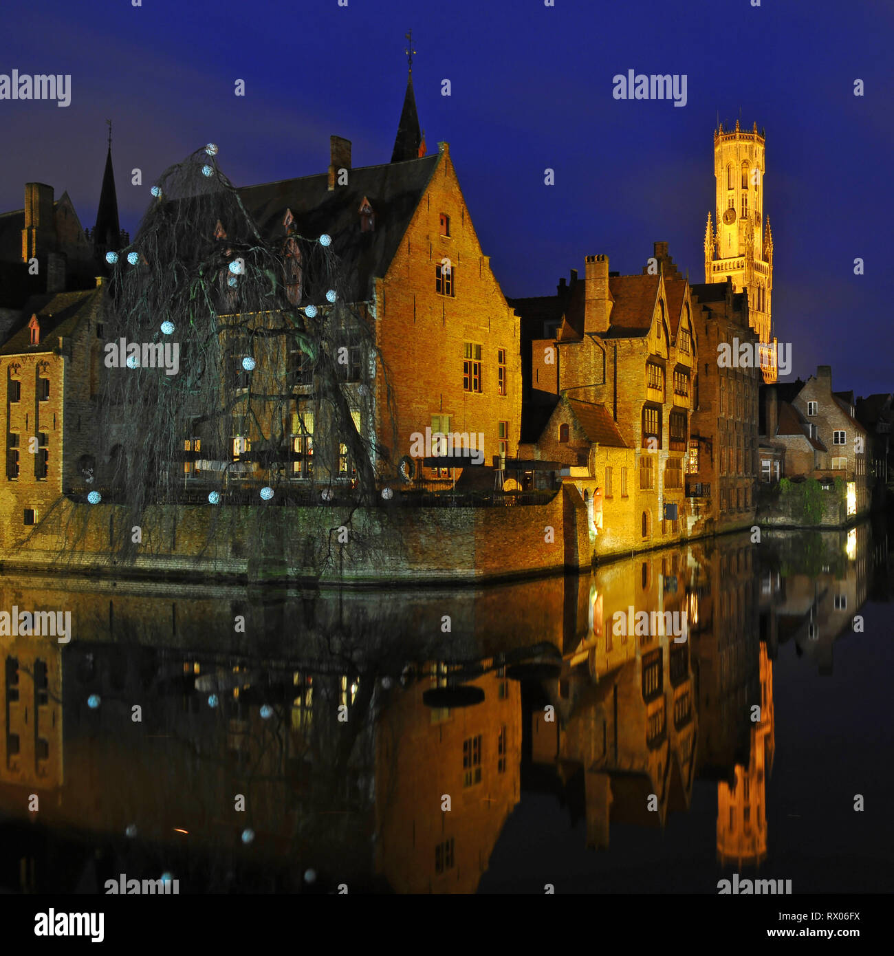 Architecture reflection at night in the medieval city center of Bruges, West Flanders, Belgium. Stock Photo