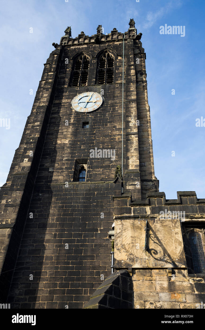 Bell tower of Halifax Minster with clock and sundial / sun dial. West Yorkshire. UK. Sunny / sun