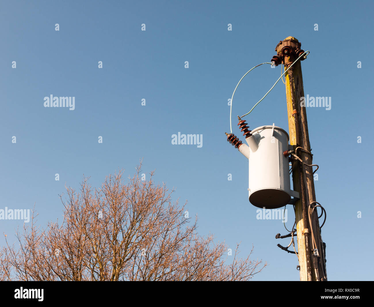 metal bucket hanging on pole electrics outside wires; essex; england