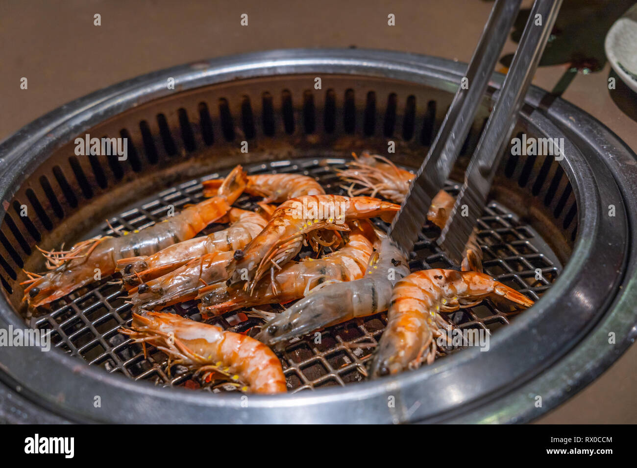 Grilled shrimp on the flaming grill, seafood background Stock Photo - Alamy
