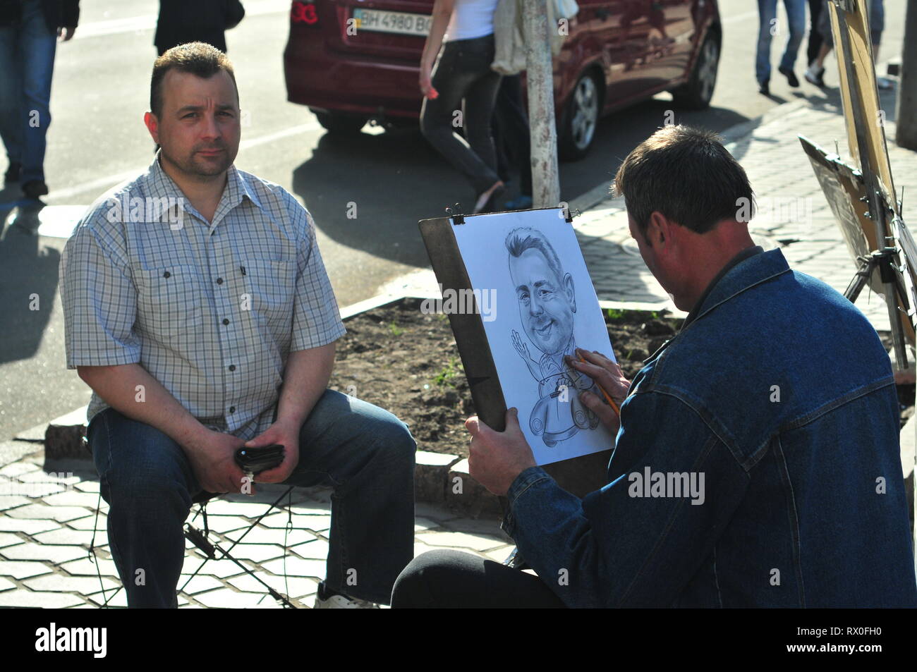 Kiev, Ukraine, Man drawing another man caricature on the street of Kiev. Stock Photo