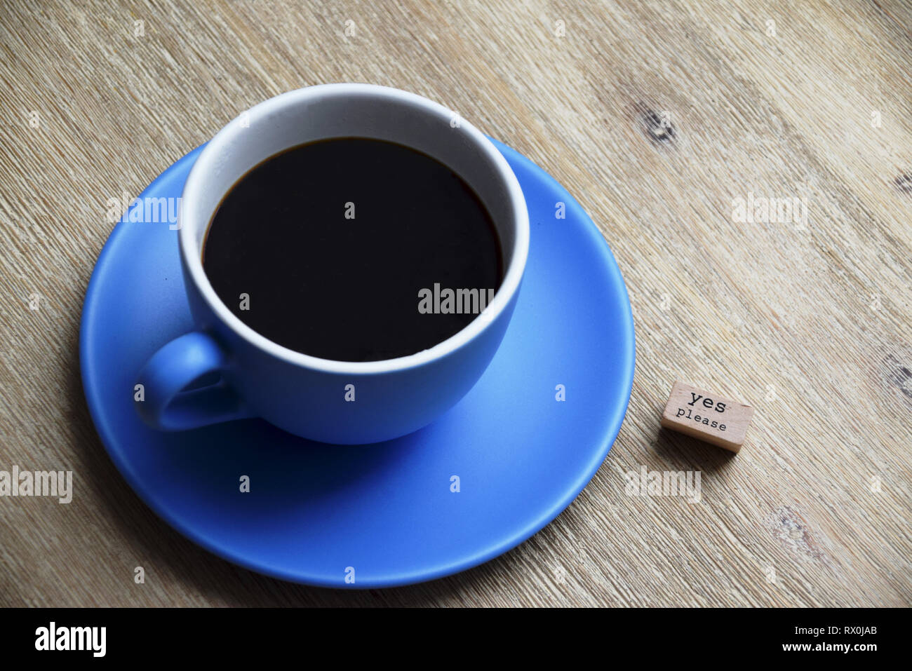 Concept of yes please to coffee with a big cup of coffee next to a