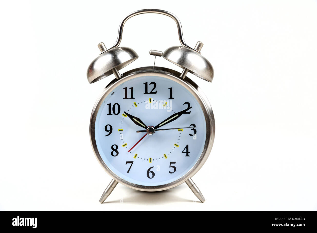 Stainless steel old fashioned alarm clock on a white background Stock ...