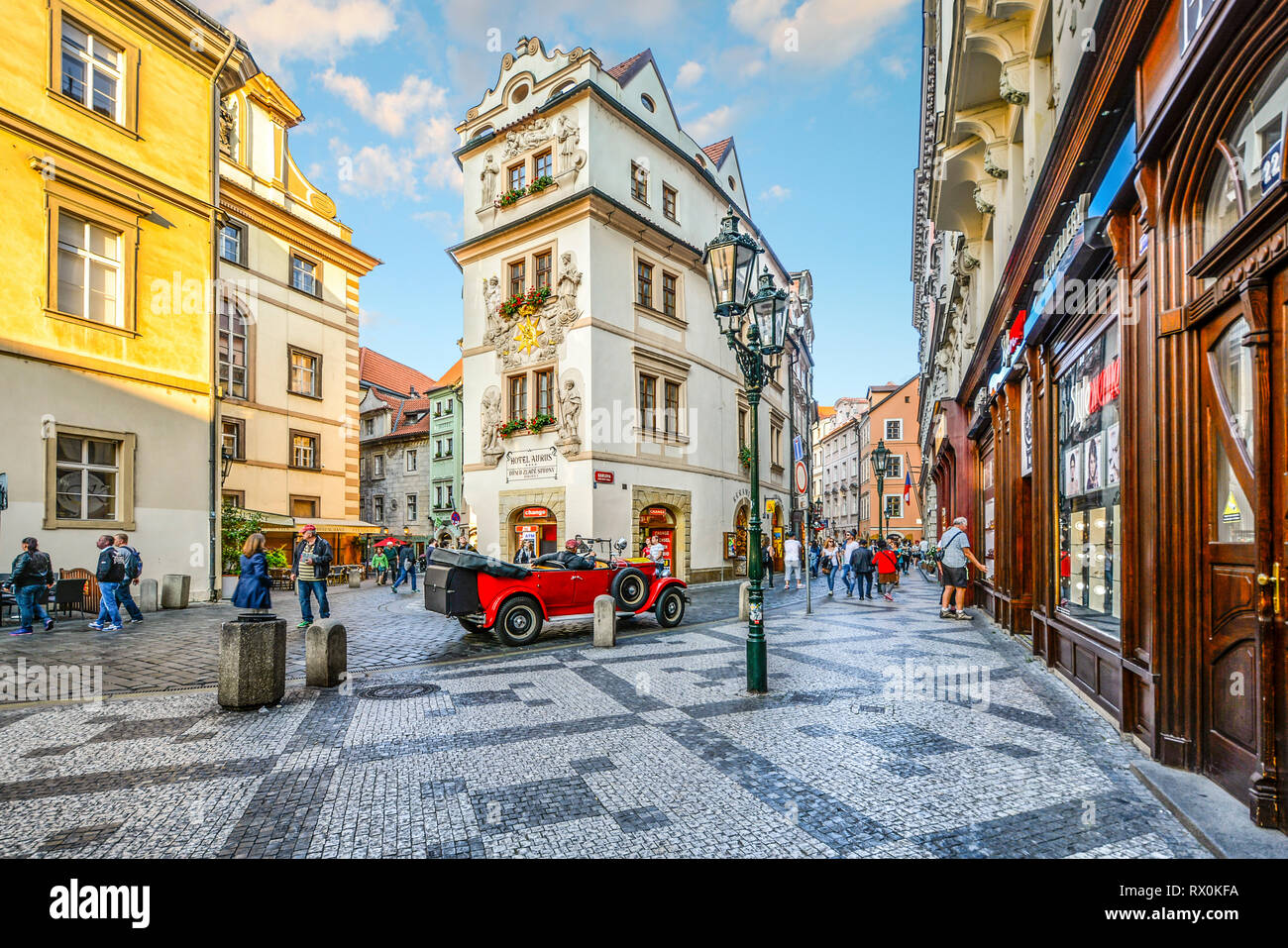 Tourists sightsee, shop and enjoy the cafes as they pass by a vintage red  automobile in a picturesque section of Old Town Prague, Czech Republic  Stock Photo - Alamy
