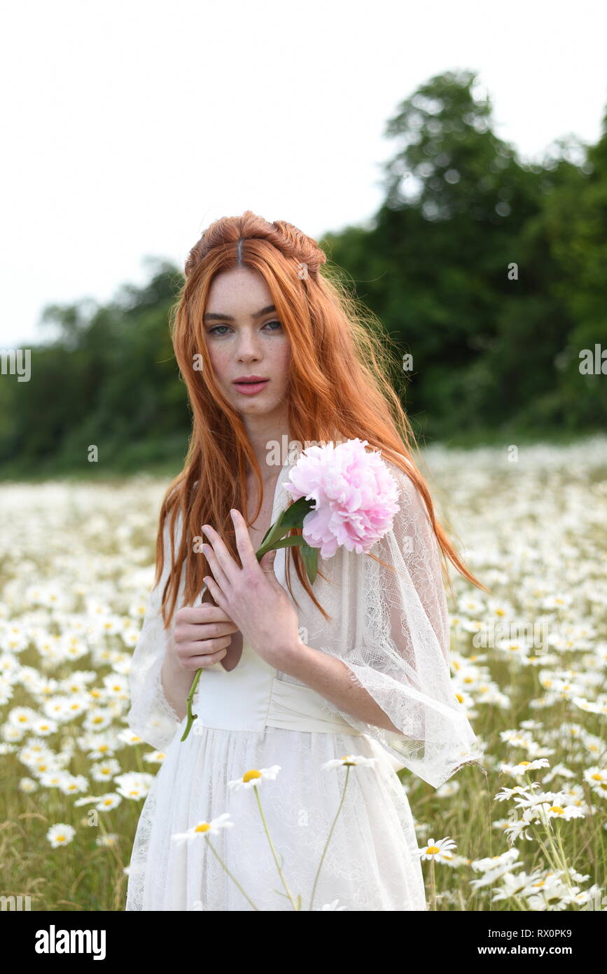 A beautiful red haired girl in a long white dress poses in the middle of a Daisy beautiful girl in a field Stock Photo - Alamy A beautiful red haired girl in a long white dress poses in the middle of a Daisy beautiful girl in a field Stock Photo - Alamy