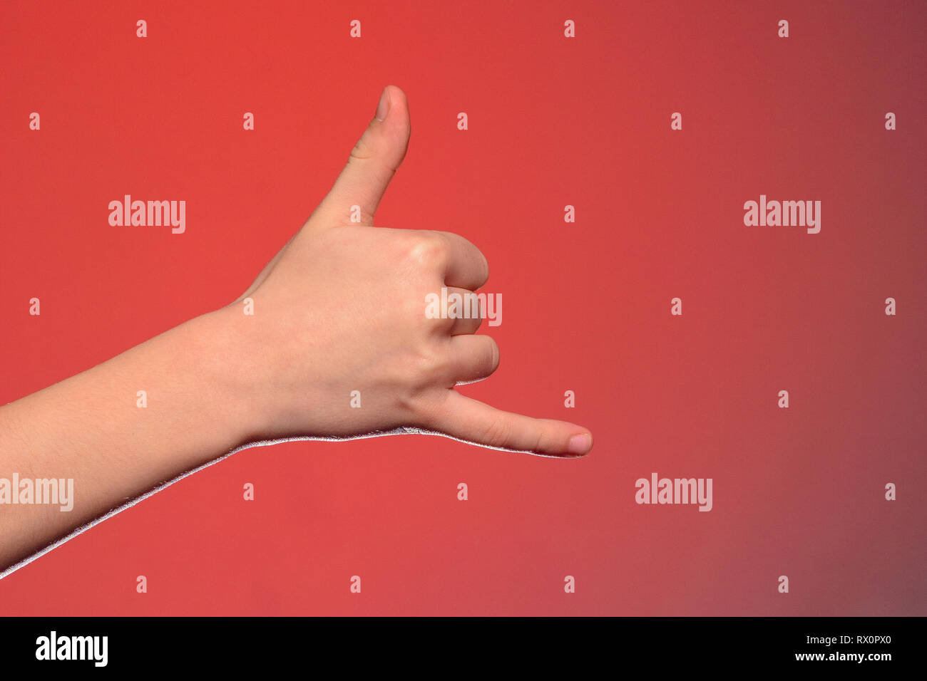 The sign of a phone call shows one-handed isolated on a red background 2019 Stock Photo
