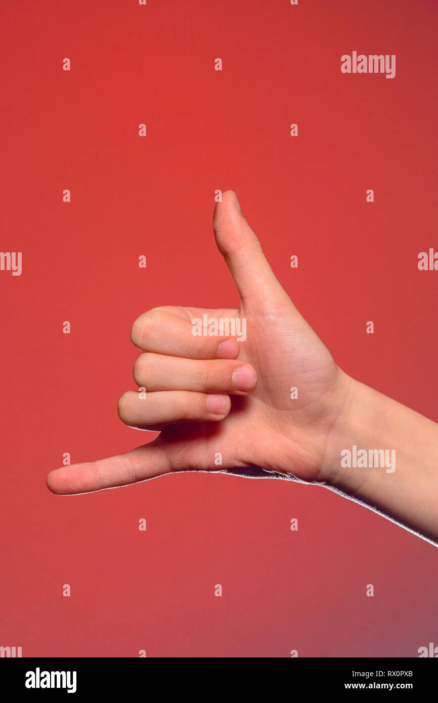 The sign of a phone call shows one-handed isolated on a red background 2019 Stock Photo