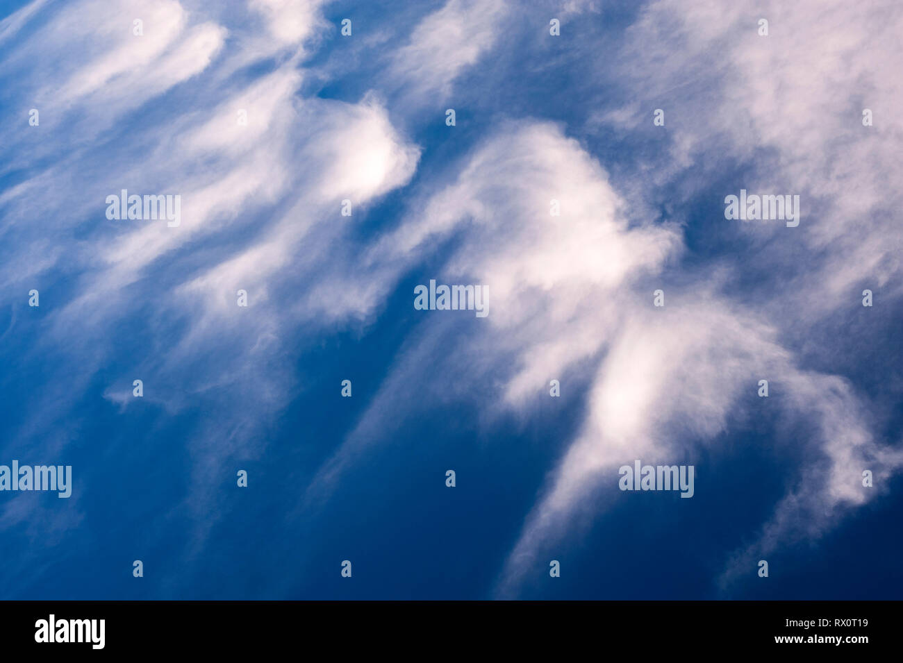 Cirrus clouds in blue sky with dramatic vision of meteorites Stock Photo