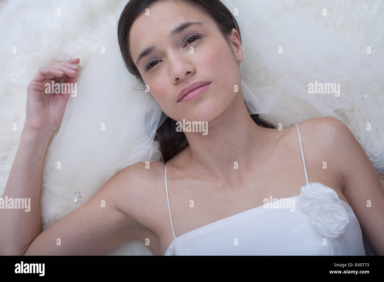 Young Woman Wearing A Wedding Dress Day Dreaming Stock Photo