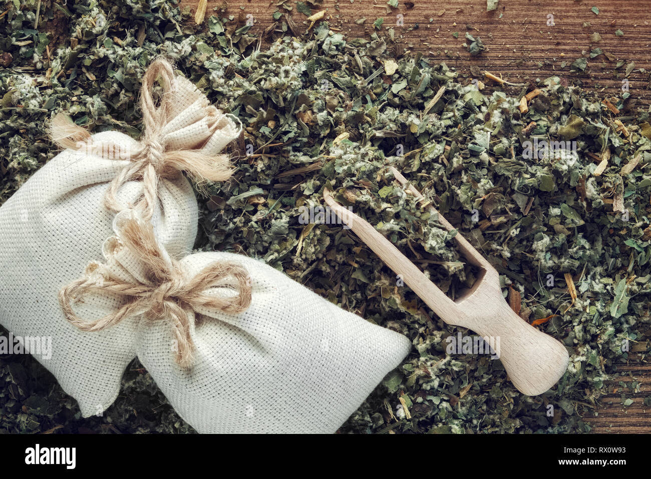 Background of dry medicinal herbs, two sachet bags of aromatic healthy