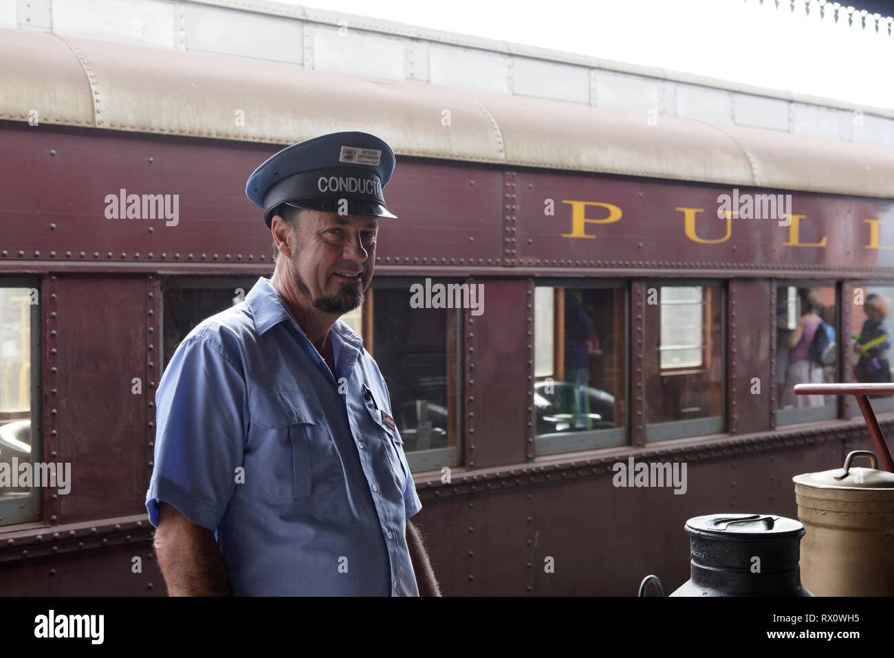 Conductor - volunteer staff member on the platform of the Historic Maldon Railway station on the Victorian Goldfields Railways, Maldon, Victoria, Aust Stock Photo