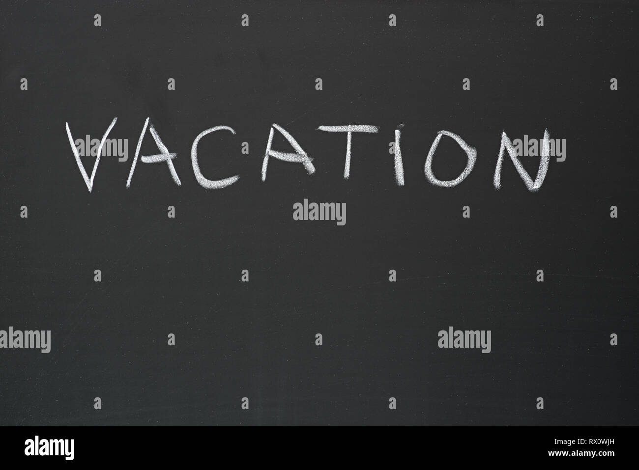 vacation hand written in chalk on a blackboard Stock Photo