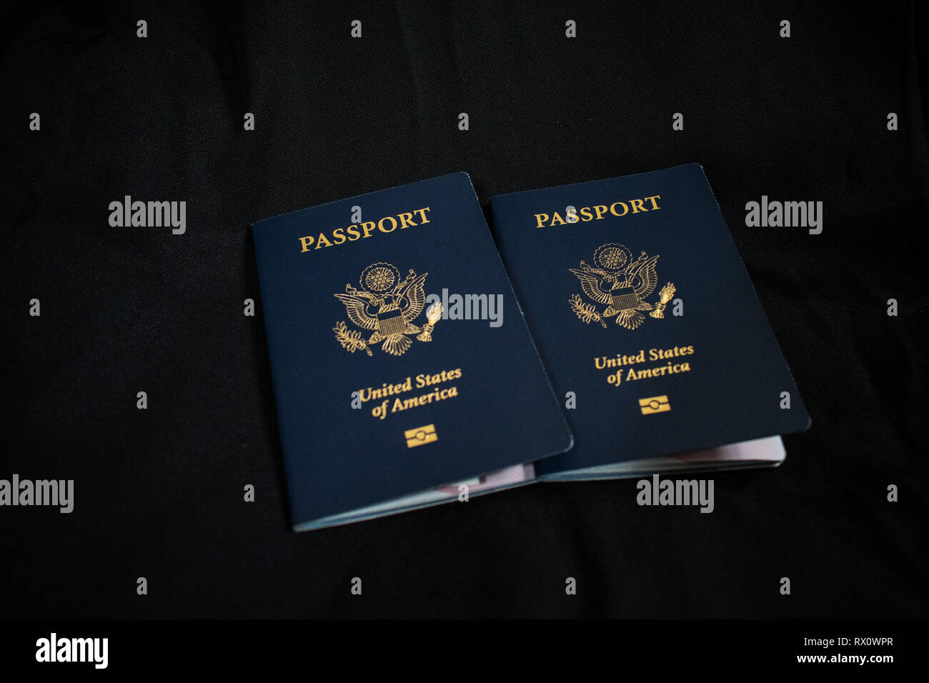 Two US passports on a black background Stock Photo