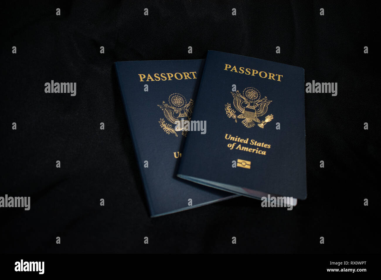 Two US passports on a black background Stock Photo