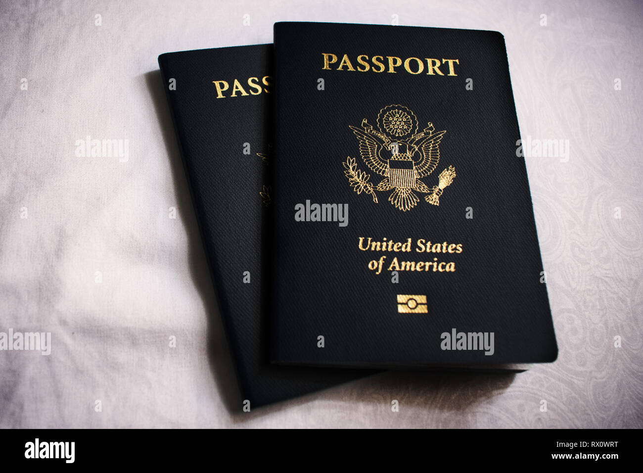 Two US passports on white background Stock Photo