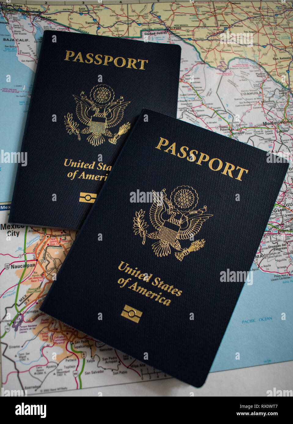 Two US passports on a map background Stock Photo