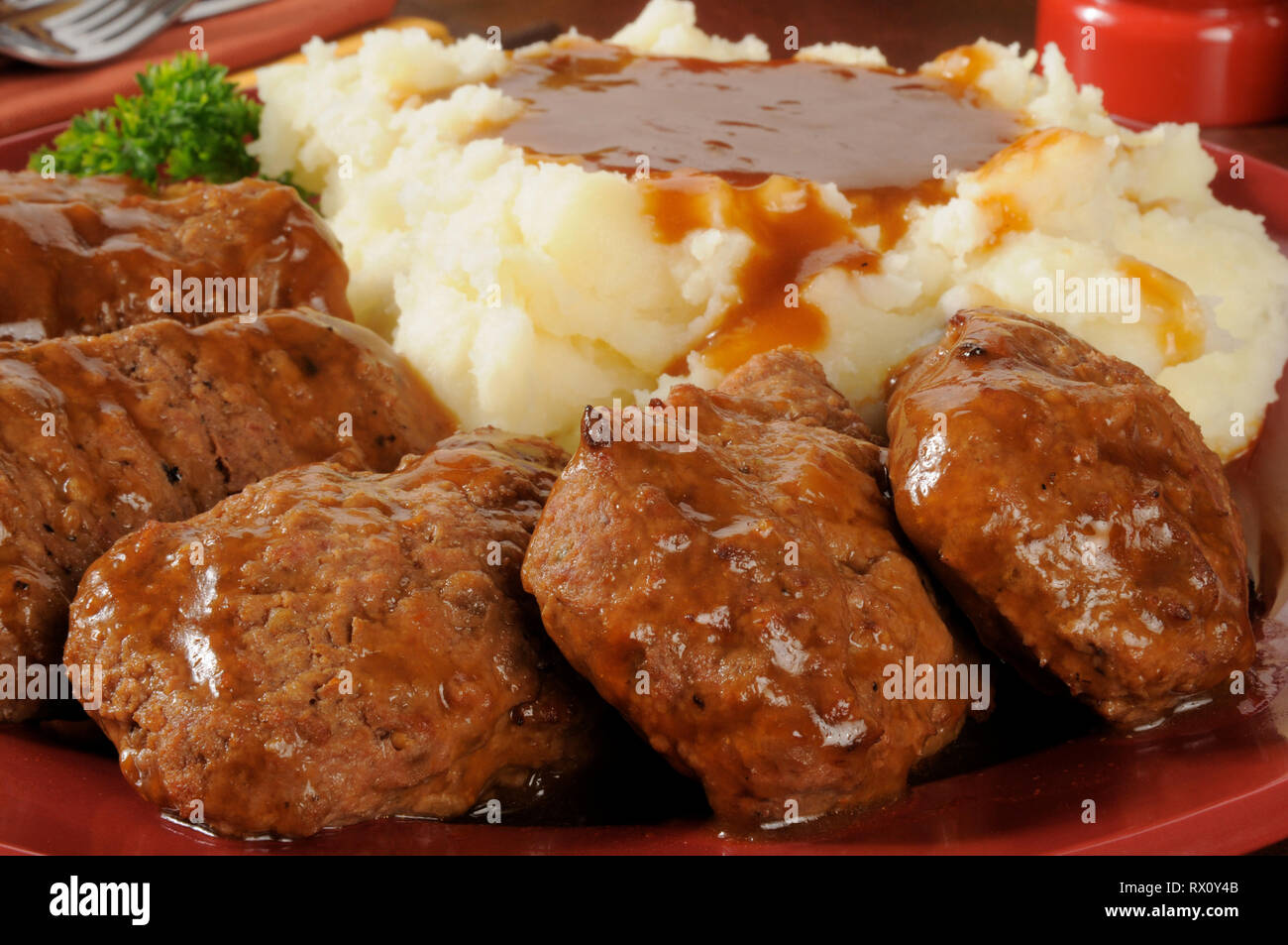 Closeup of a platter of meatloaf and mashed potatoes and gravy served