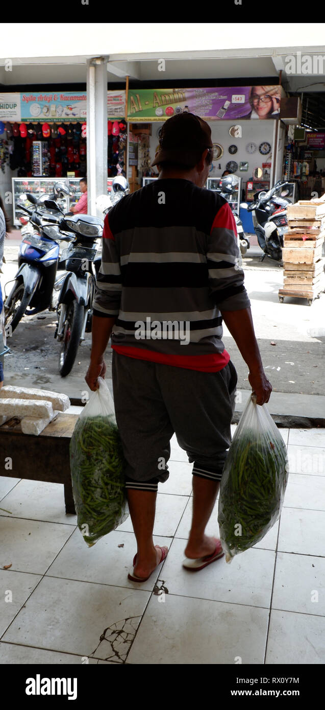 people carrying items in plastic bags Stock Photo - Alamy