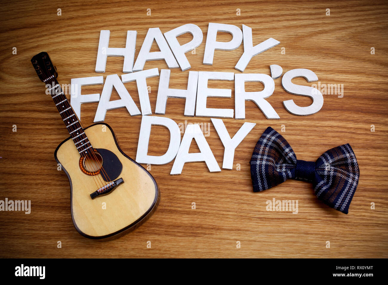 Happy Fathers Day letters with guitar on wooden background. Top view ...