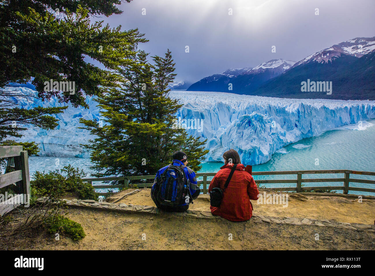 PERITO MORENO, ARGENTINA, A tourist couple admires the the edge of glacier frim a safe view point Stock Photo
