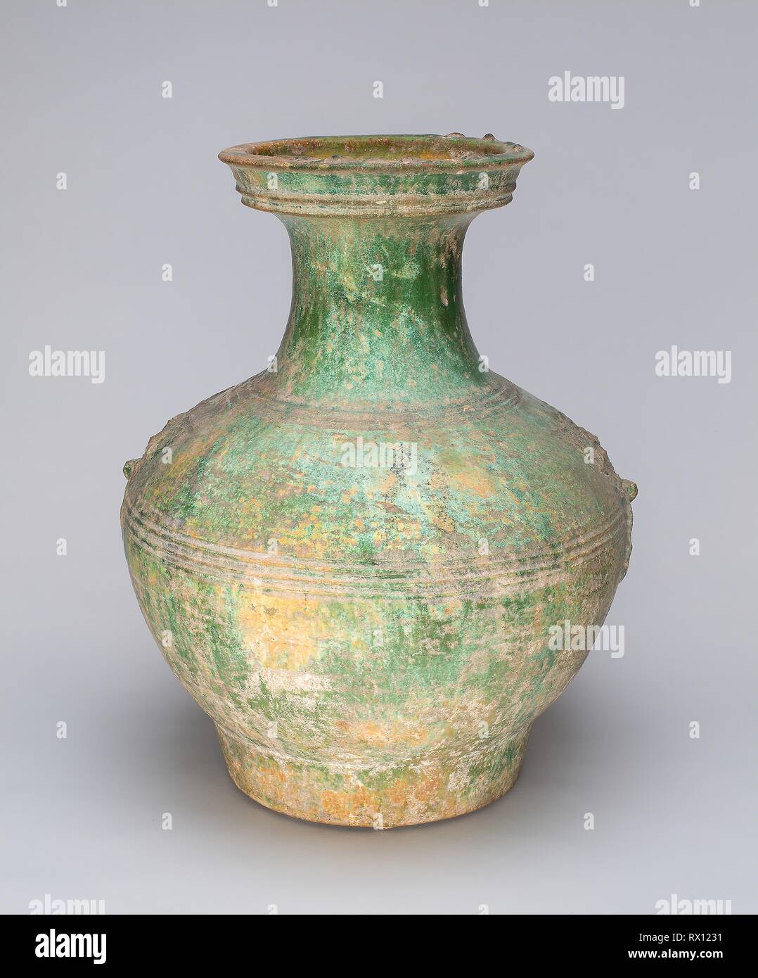 Han Dynasty Pottery Jar with Green Glaze and Molded Masks as Applied Handles Han Dynasty Pottery Jar with Green Glaze and Molded Masks as Applied Handles