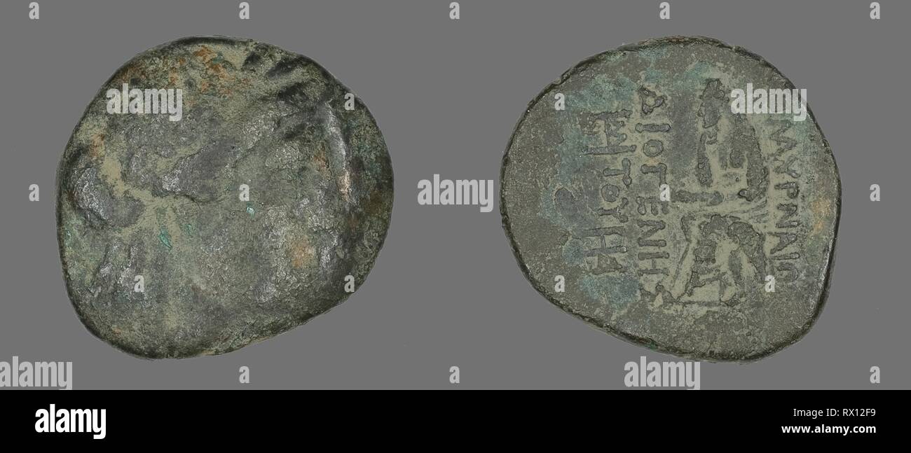 Coin Depicting the God Apollo. Greek. Date: 200 BC-1 BC. Dimensions: Diam. 2.3 cm; 7.96 g. Bronze. Origin: Ancient Greece. Museum: The Chicago Art Institute. Stock Photo