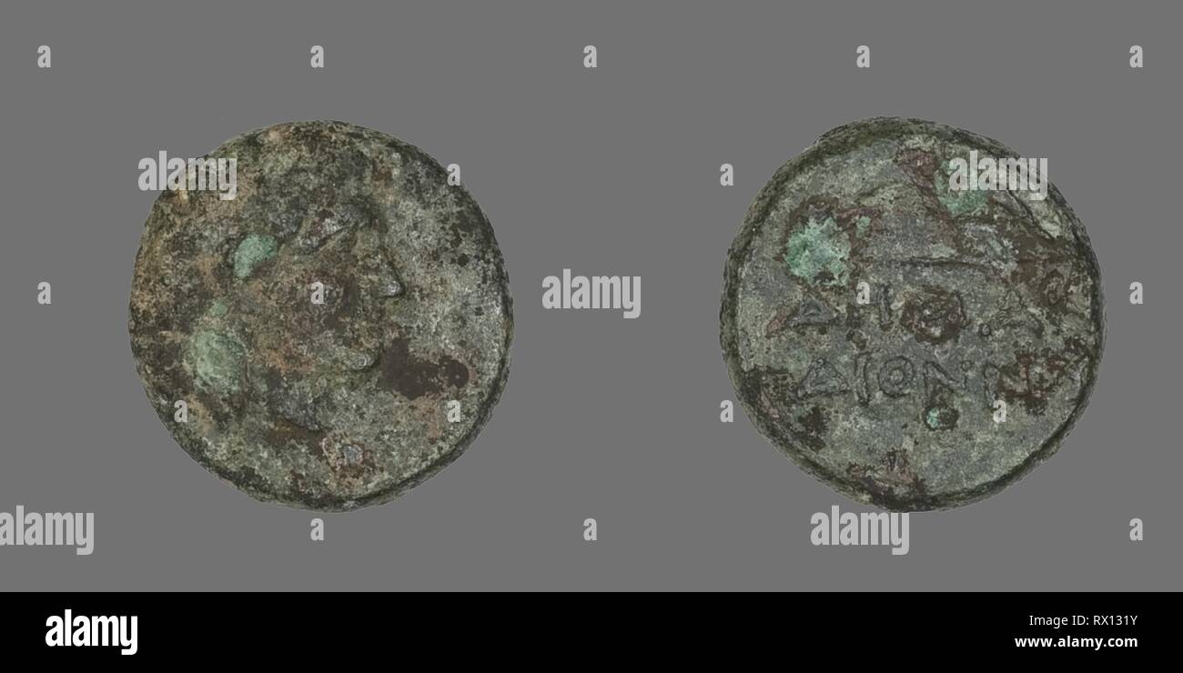 Coin Depicting the God Apollo. Greek. Date: 300 BC-200 BC. Dimensions: Diam. 1.2 cm; 1.89 g. Bronze. Origin: Ancient Greece. Museum: The Chicago Art Institute. Stock Photo