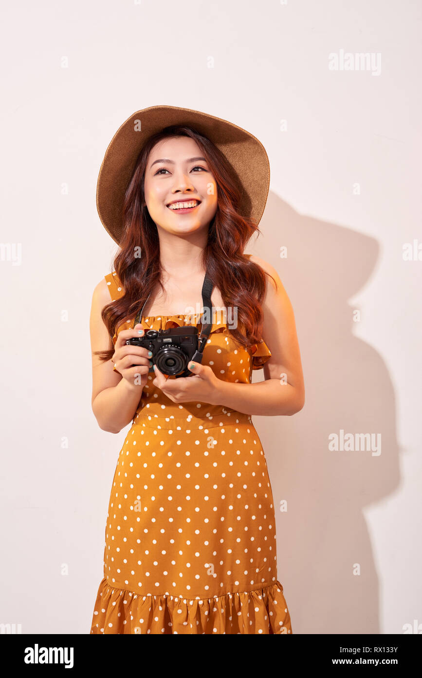 Image of young photographer woman isolated over beige background wall ...