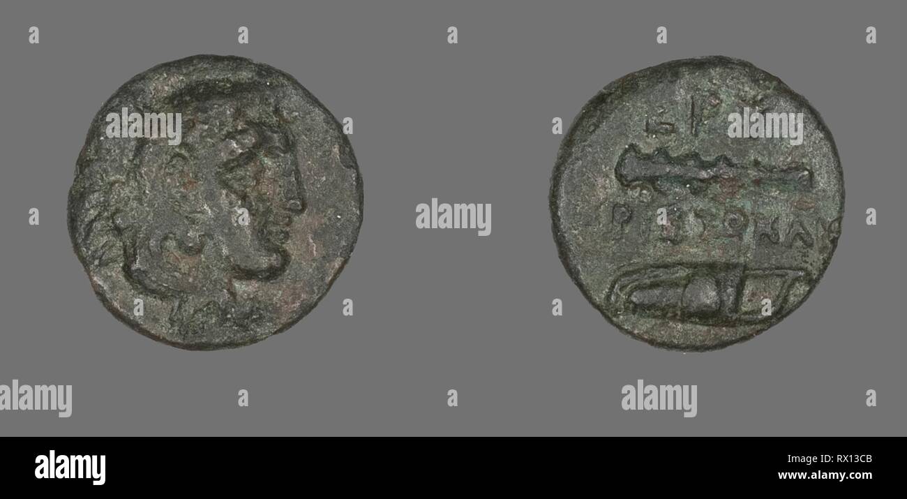 Coin Depicting the Hero Herakles. Greek. Date: 400 BC-301 BC. Dimensions: Diam. 1.3 cm; 1.40 g. Bronze. Origin: Ancient Greece. Museum: The Chicago Art Institute. Stock Photo