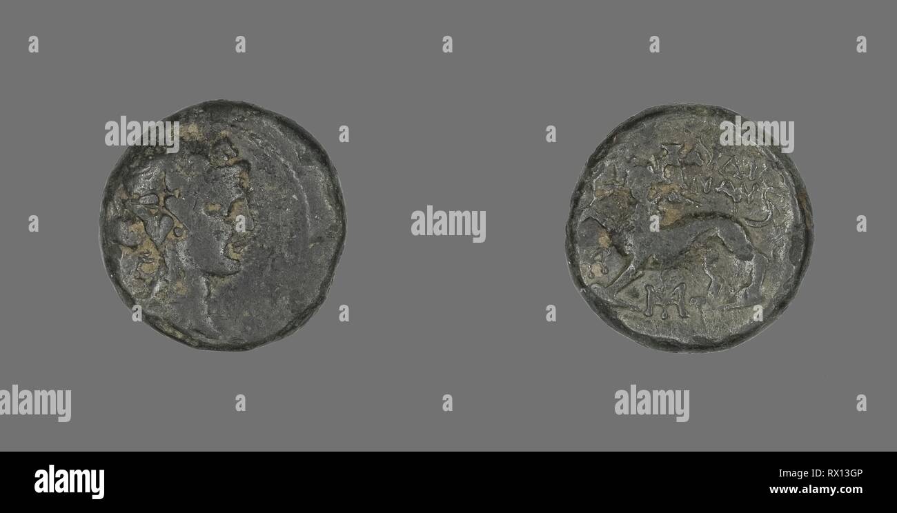 Coin Depicting the God Dionysos. Greek. Date: 133 BC. Dimensions: Diam. 1.7 cm; 5.23 g. Bronze. Origin: Ancient Greece. Museum: The Chicago Art Institute. Stock Photo
